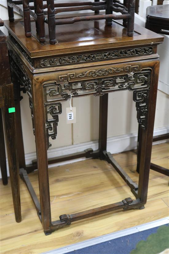 A Chinese huali wood urn stand, having panelled top and pierced frieze W.52cm